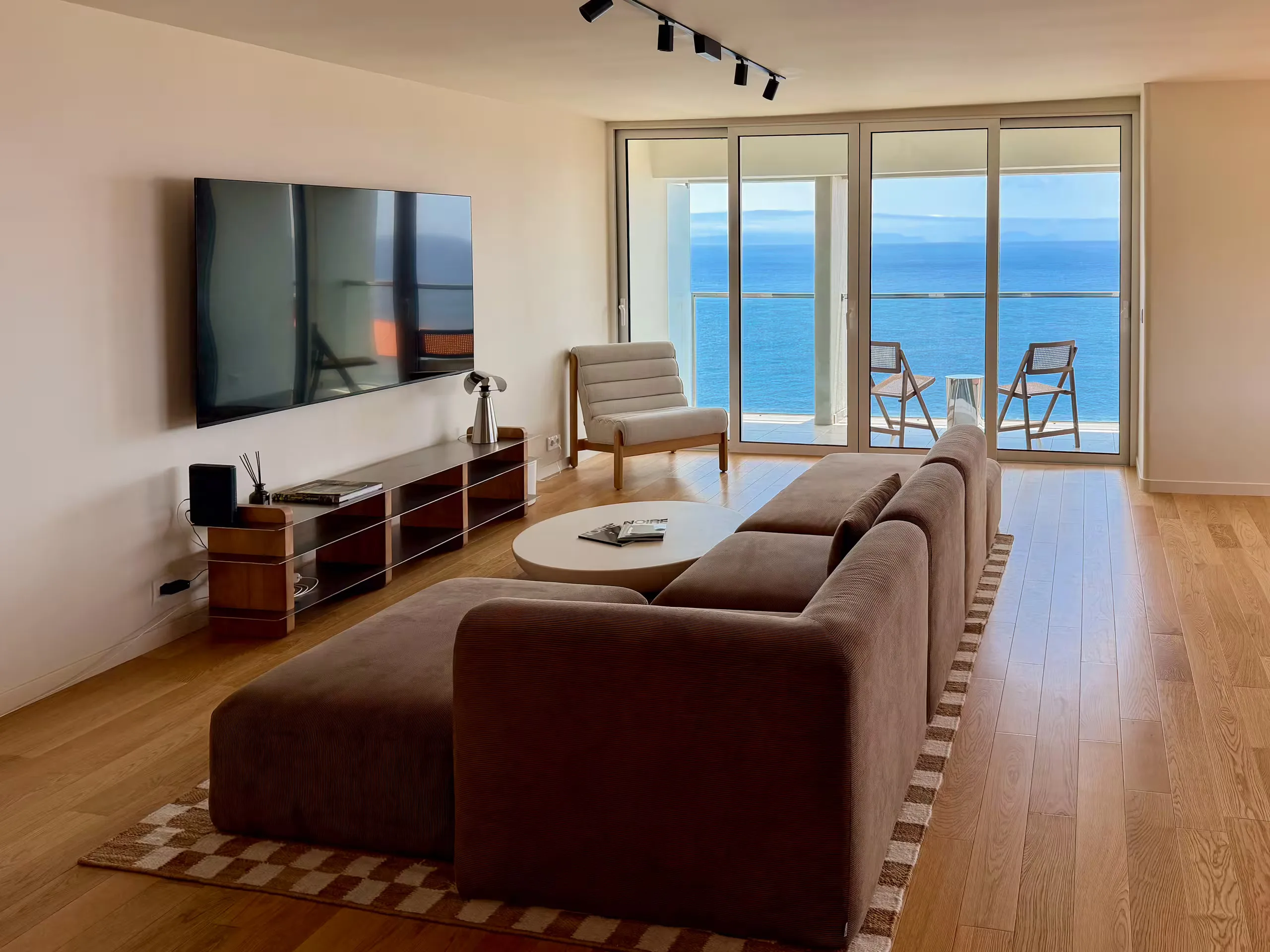 The same living room, furnished and styled for guests
