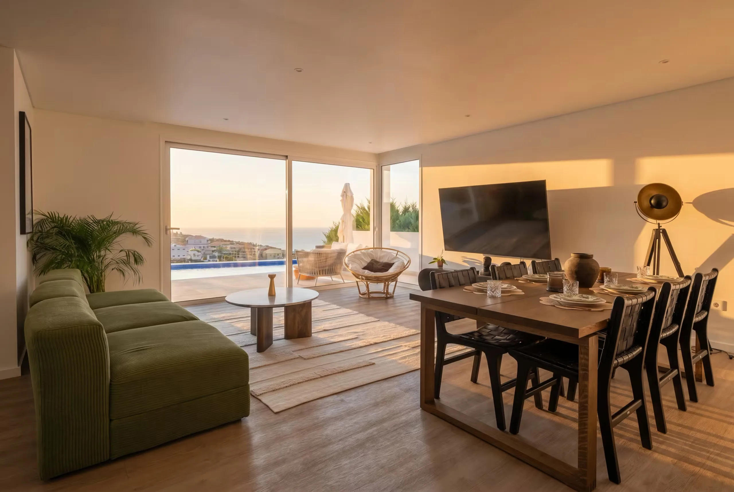 The same living room, furnished for golden-hour evenings